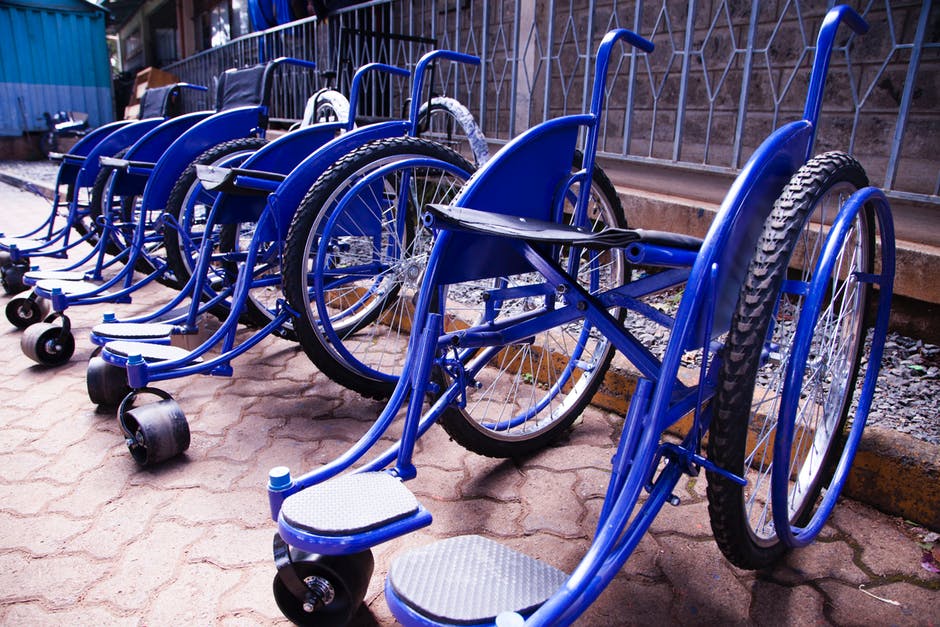 Blue wheelchairs lined up for the use of people