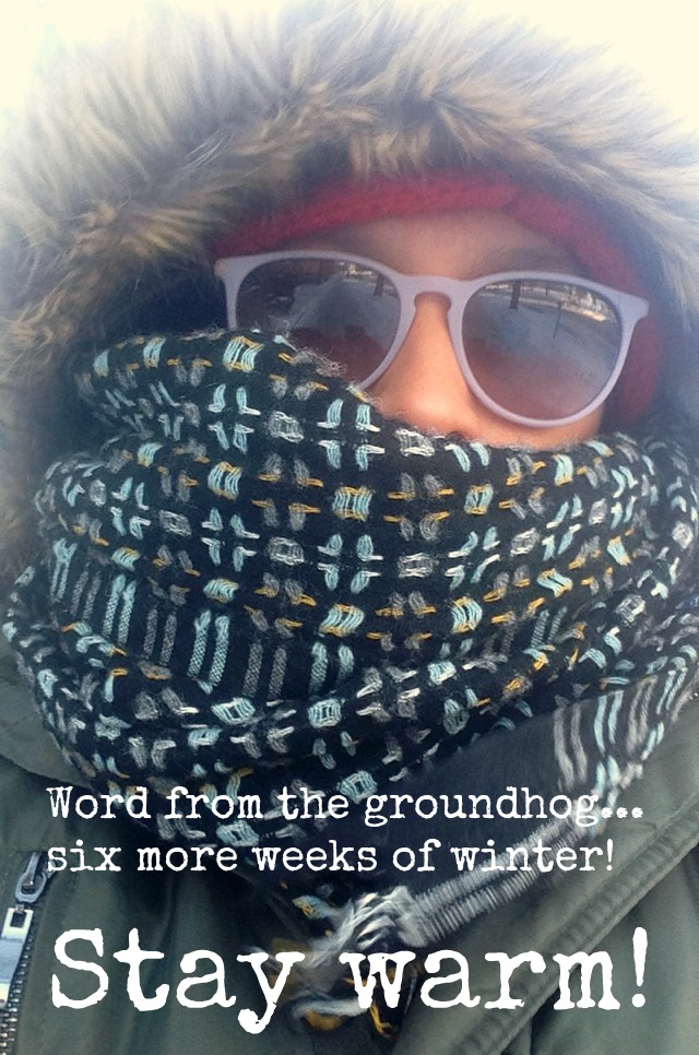 Woman with fur hood, scarf, glasses to protect her eyes from the freezing wind and snow