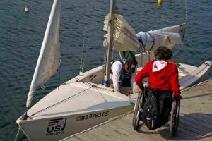 Person in a wheel chair getting ready to launch a sailboat