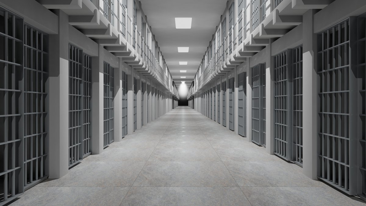 Black and White photo of an empty jail wing at a private correctional facility.