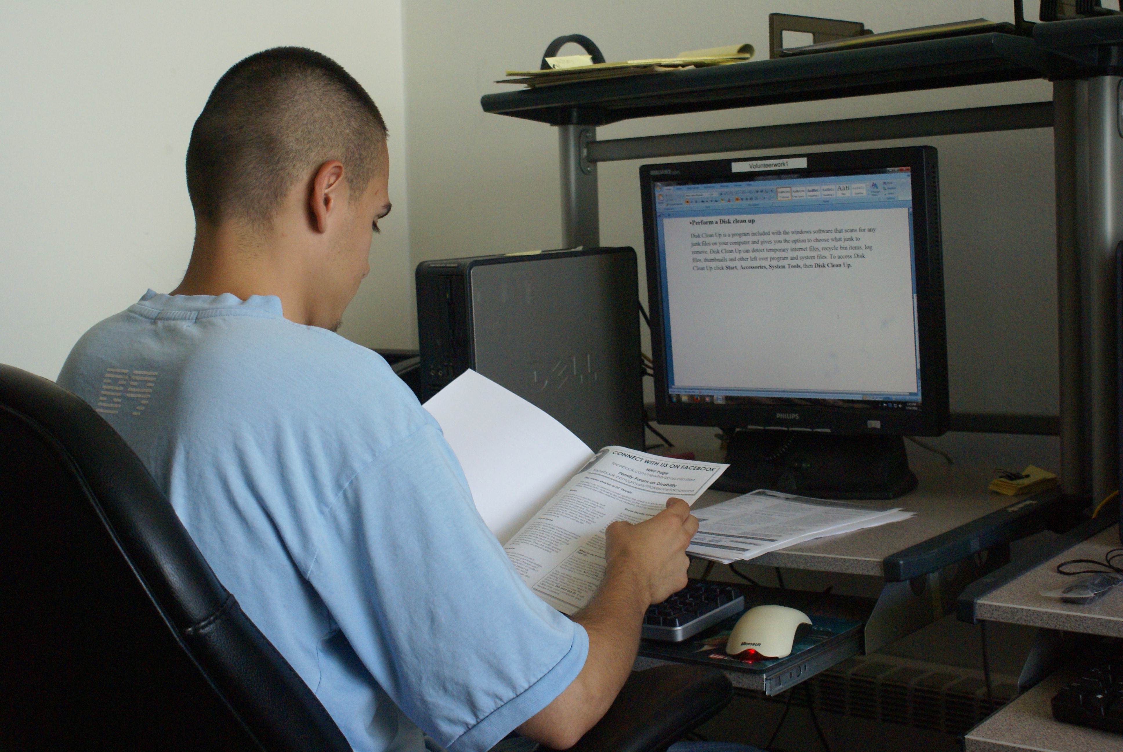 Chris, NHU Intern, sitting at a computer